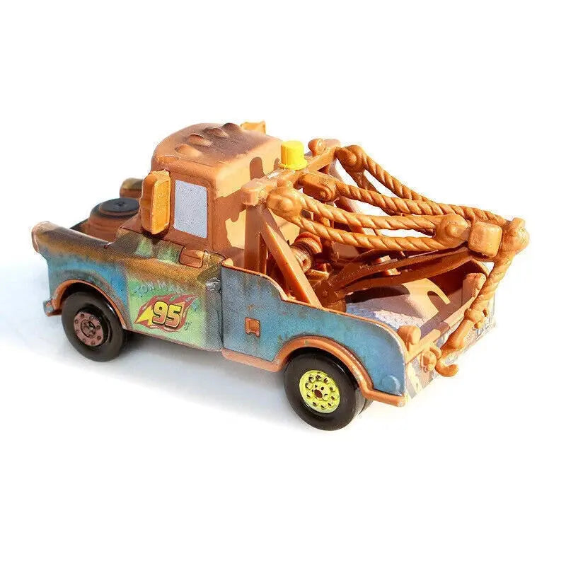 Rusty toy tow truck with blue and brown paint, number 95 decal, and orange tow cables