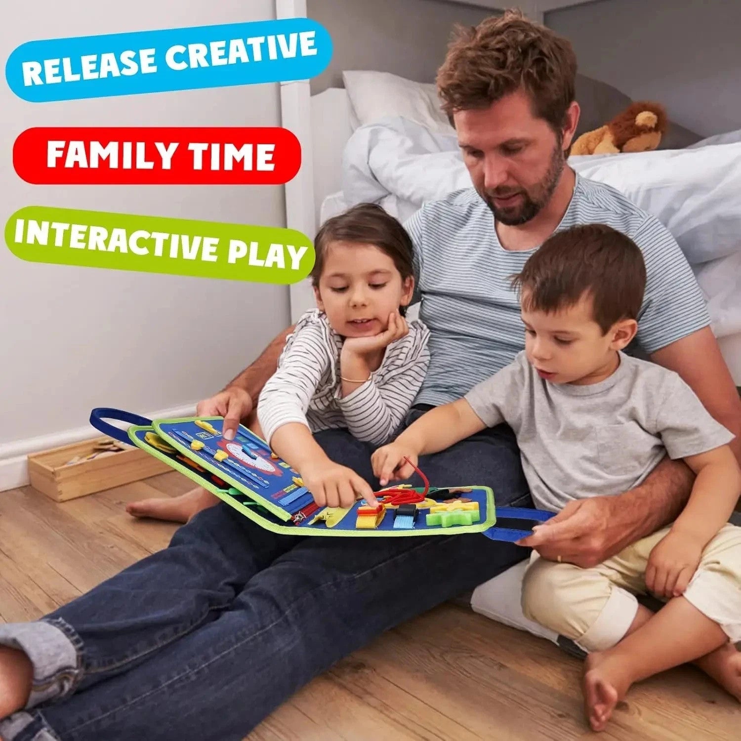 Father with two kids sitting on wooden floor playing interactive educational toy book