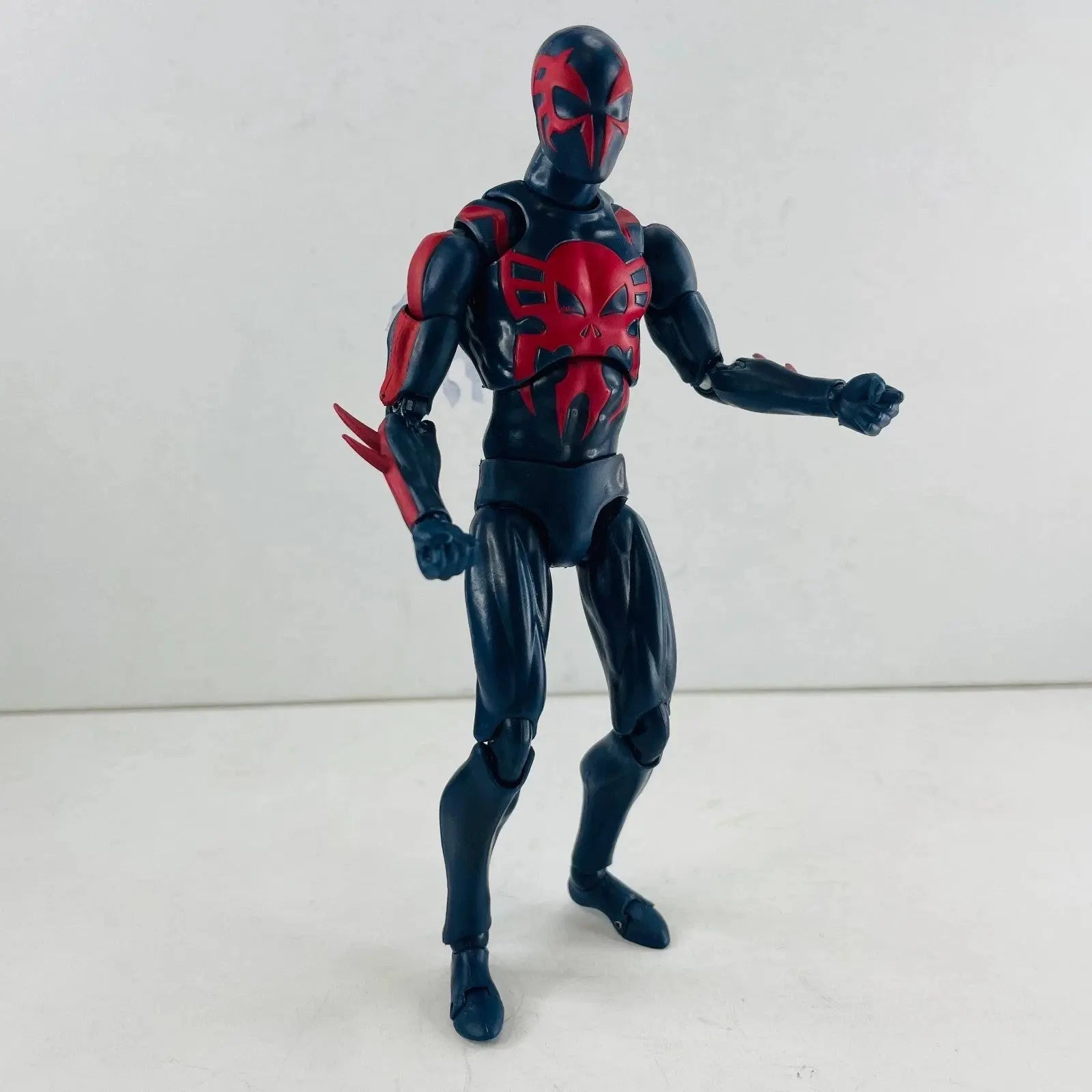 Articulated black and red action figure with spider-like chest design on white background