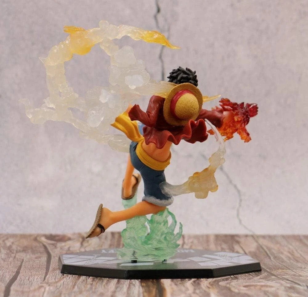 One Piece Luffy figure with straw hat, red jacket, and flaming fist effect on wooden surface
