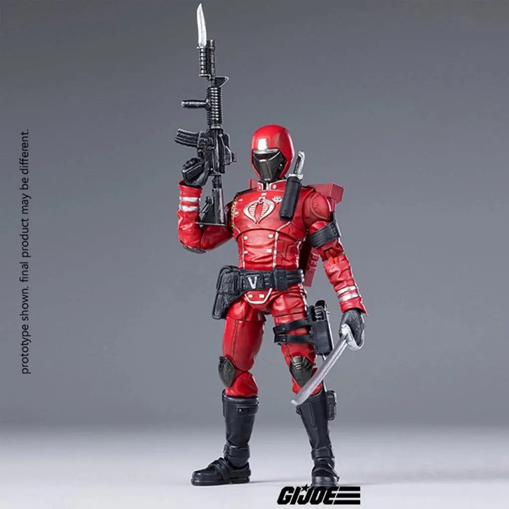GI Joe action figure in red uniform with black helmet holding gun and sword on gray background