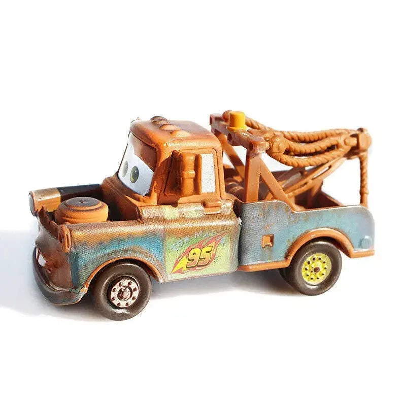 Rusty brown and blue tow truck toy with eyes, 95 decal, and rope tow cables