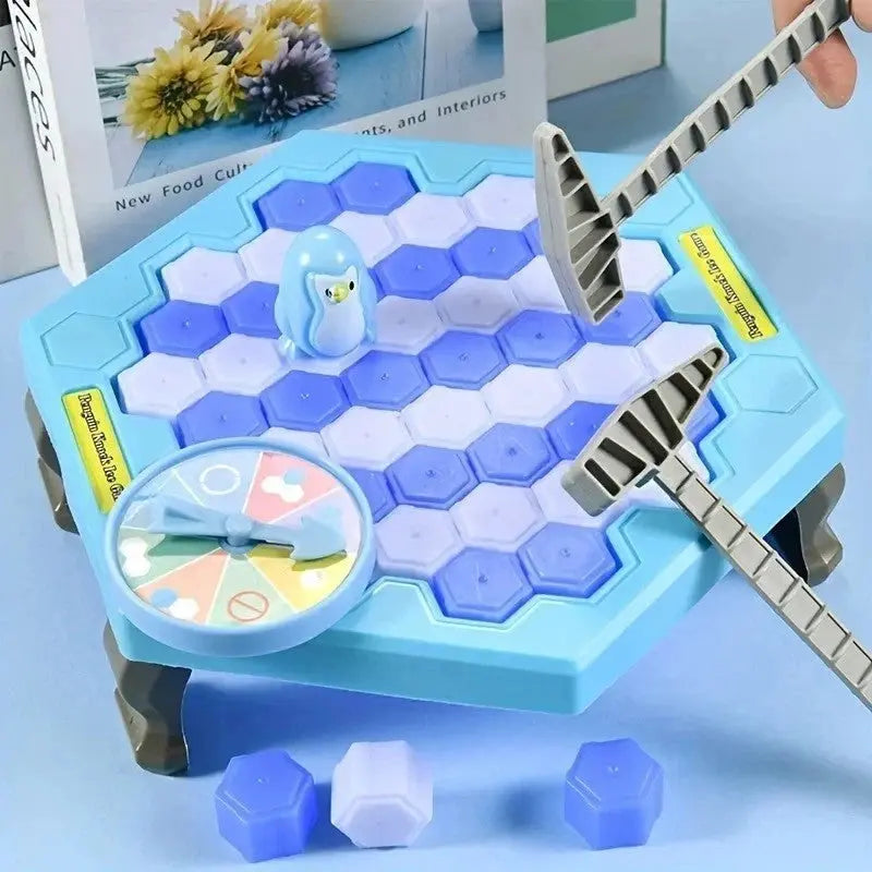 Blue hexagonal penguin ice breaking game with plastic hammers and spinning wheel on table