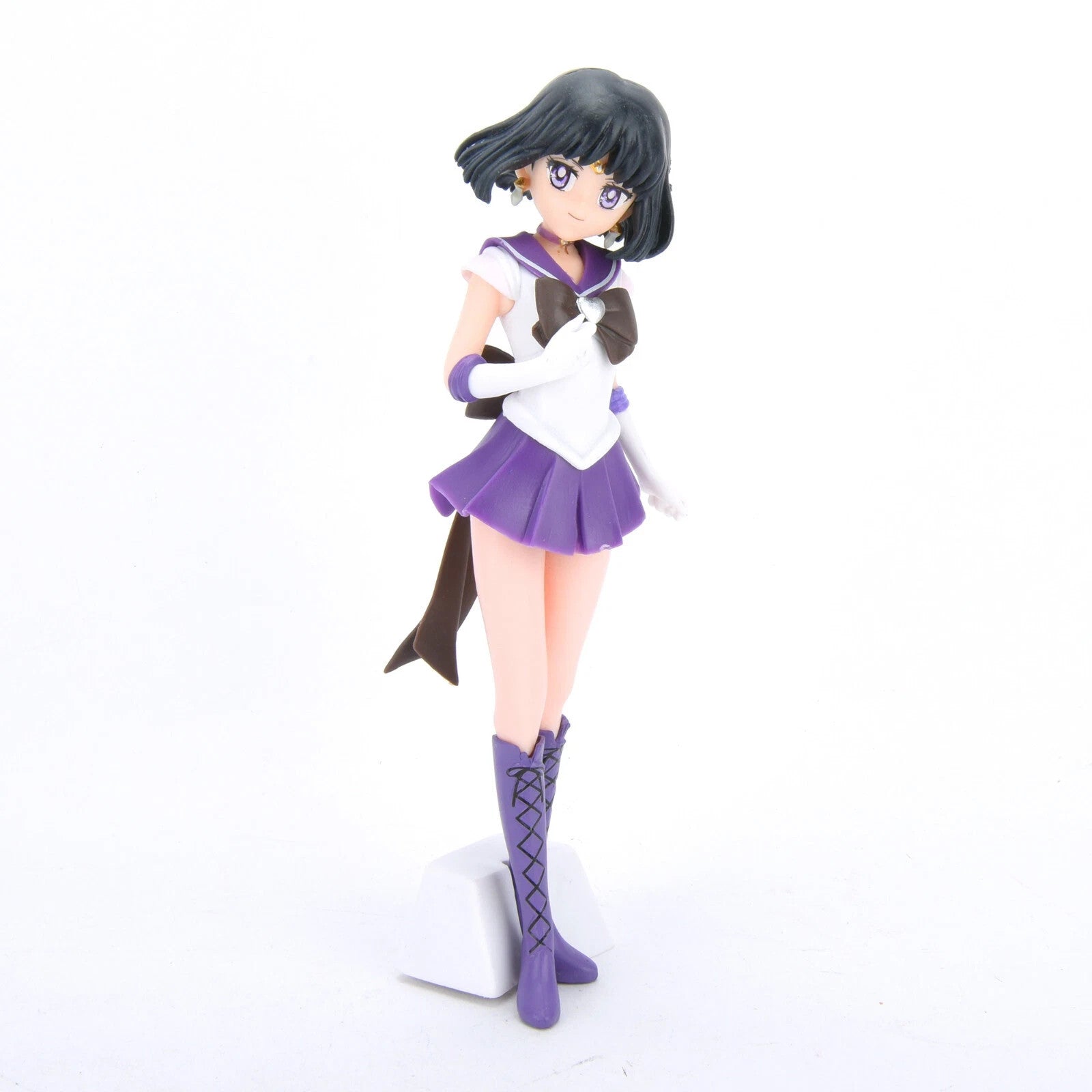 Sailor Saturn anime figurine in purple skirt and boots with white gloves on white background